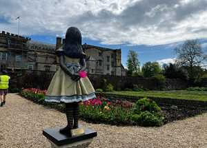 Alice & Wonderland Statue holding flower at Forde Abbey House & Gardens