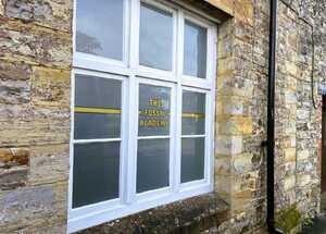 After - Silver Etched Privacy Film With Custom Gold Lettering Window Graphics