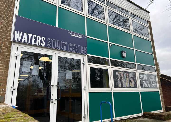 Exterior of a building with a sign reading "WATERS STUDY CENTRE" above a glass door and windows.