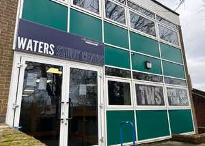 Exterior of a building with a sign reading "WATERS STUDY CENTRE" above a glass door and windows.