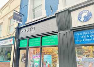 After Enhancing Footeprints' Storefront with a Fujifilm Photo Shop Fascia Sign and Custom Window Graphics