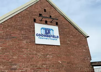 Sign on a brick building reads "Coombe Field Veterinary Hospital."