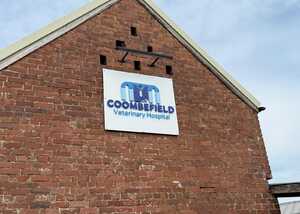Sign on a brick building reads "Coombe Field Veterinary Hospital."
