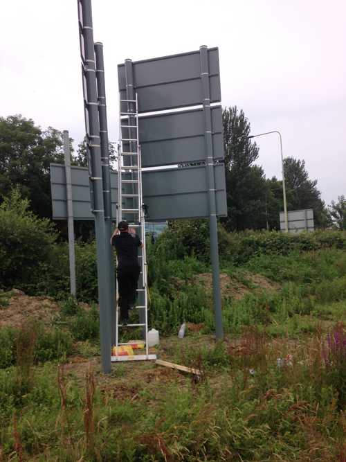 The signage being installed Post mounted sign installation