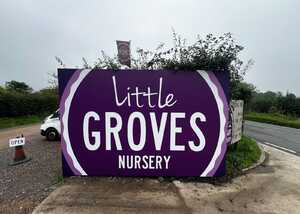 Sign for "Little Groves Nursery" in purple and white lettering, with greenery in the background.