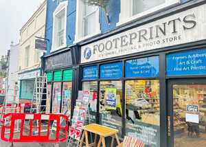Before Enhancing Footeprints' Storefront with a Fujifilm Photo Shop Fascia Sign and Custom Window Graphics