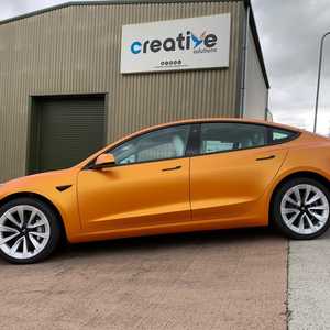 Full Metallic Orange Vehicle Wrap on Tesla