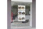 Floor to ceiling cables used within an estate agent's window display.jpg