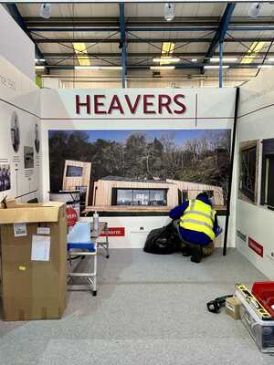 Custom Trade Show Stand for Heavers of Bridport - Installing Rollable Shell Scheme Graphics