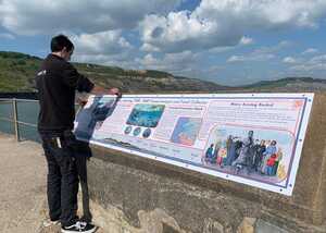 Informational sign about Mary Anning on the Lyme Regis seafront.