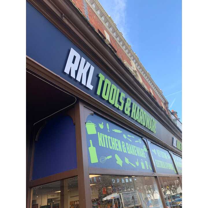 Storefront sign for RKL Tools & Hardware, featuring kitchen and garden icons.