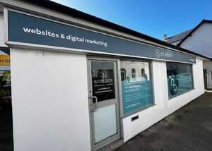 Exterior of a building with a sign reading "websites & digital marketing."