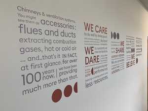 Installing new wall display - cut vinyl typography print for business