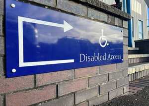 Sign indicating "Disabled Access" with an arrow pointing left.