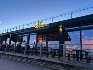 SWIM Illuminated Lettering Signage Mounted Above Restaurant Entrance