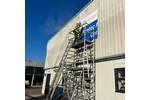 Installing Large Printed Aluminium Sign Panel for Exeter Mobility Centre. Installed in 4 sections..jpg