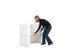 lady adding the storage shelf to the Action promotional display counter.jpg