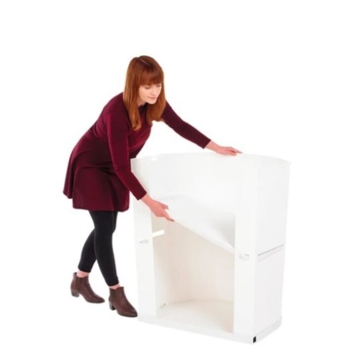 Lady adding the storage shelf to the Rapido promotional display counter..jpg