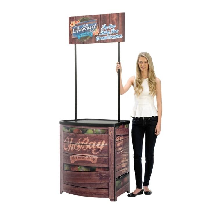 Lady standing next to completed Demo Center promotional display counter..jpg