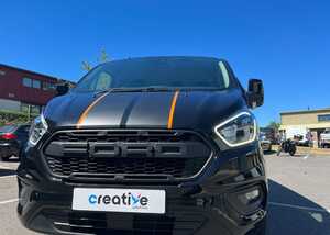 Expertly peeling back the vinyl backing sheet for a gloss finish vehicle graphic installation