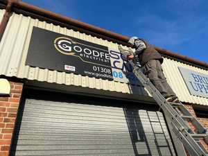 Installing Sign to Prefabricated Steel Industrial Building Workshop