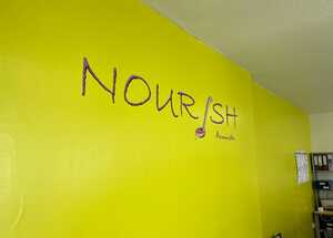 Welcome To Nourish! Freshly branded wall with vinyl text and logo application
