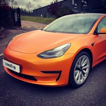 Orange Vinyl Wrap for Tesla Model 3 - Front View Orange Vinyl Wrap for Tesla Model 3 - Front View