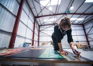 Member of staff expertly cutting vinyl in our cutting-edge vehicle graphic facility