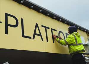 Applying large vinyl graphics to the train carriage Applying large vinyl graphics to the train carriage
