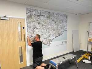 Applying custom printed map with a whiteboard laminate applied for the finished frameless magnetic whiteboard wall Applying custom printed map with a whiteboard laminate applied for the finished frameless magnetic whiteboard wall