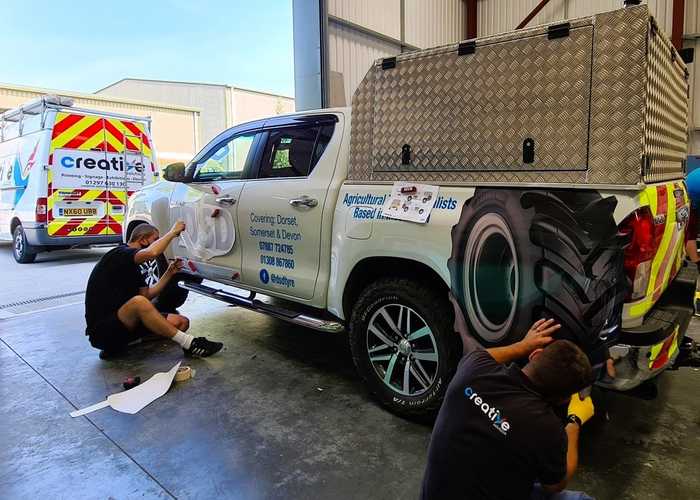 Installing cut vinyl vehilce graphics and reflective chevron kit to truck