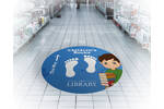 Signtac Self-Adhesive Floor Graphic in a shop showing library artwork.jpg
