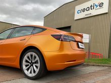 Orange Vinyl Wrap for Tesla Model 3 - Rear Profile Orange Vinyl Wrap for Tesla Model 3 - Rear Profile