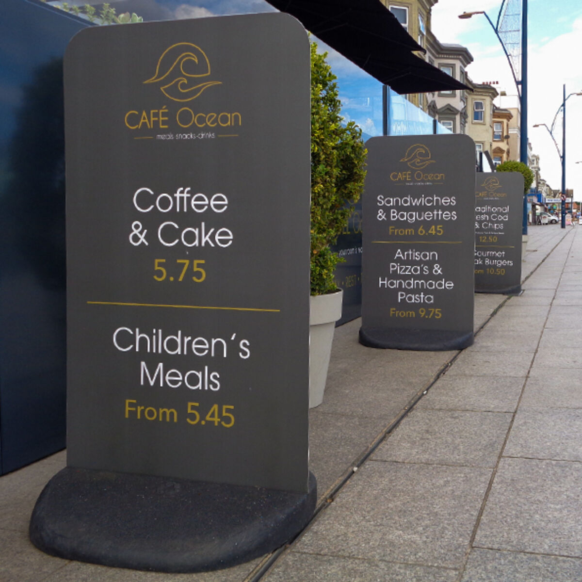 Three Ecoflextra_s outside restaurant showing Cafe Ocean artwork.jpg