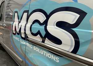 Close Up Branding Graphics on Silver Van