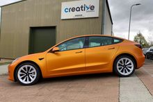 Orange Vinyl Wrap for Tesla Model 3 - Side Profile Orange Vinyl Wrap for Tesla Model 3 - Side Profile
