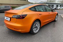 Orange Vinyl Wrap for Tesla Model 3 - Rear Side Profile Orange Vinyl Wrap for Tesla Model 3 - Rear Side Profile