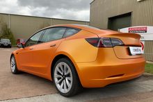 Orange Vinyl Wrap for Tesla Model 3 - Rear Profile Orange Vinyl Wrap for Tesla Model 3 - Rear Profile