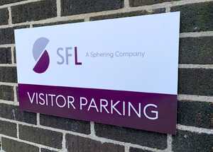 Business Parking Signs Mounted Near New Electrical Car Charging Ports