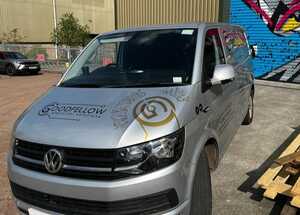 Passenger Side View of Silver Ford Transit With Branding Graphics Applied