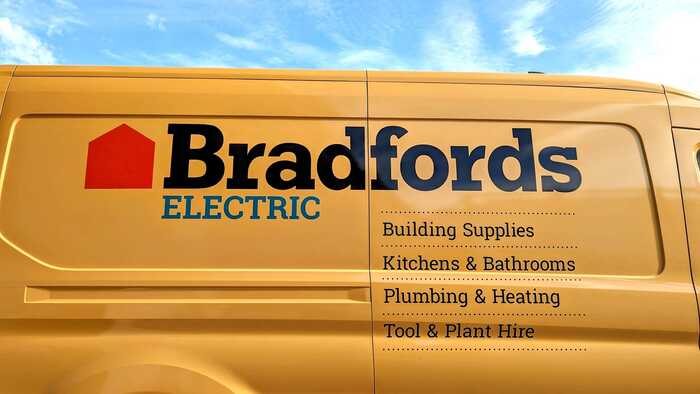 The instantly recognisable Bradfords Building Supplies Branding On The Side Of Their New Ford E-Transit Van In The Sunshine