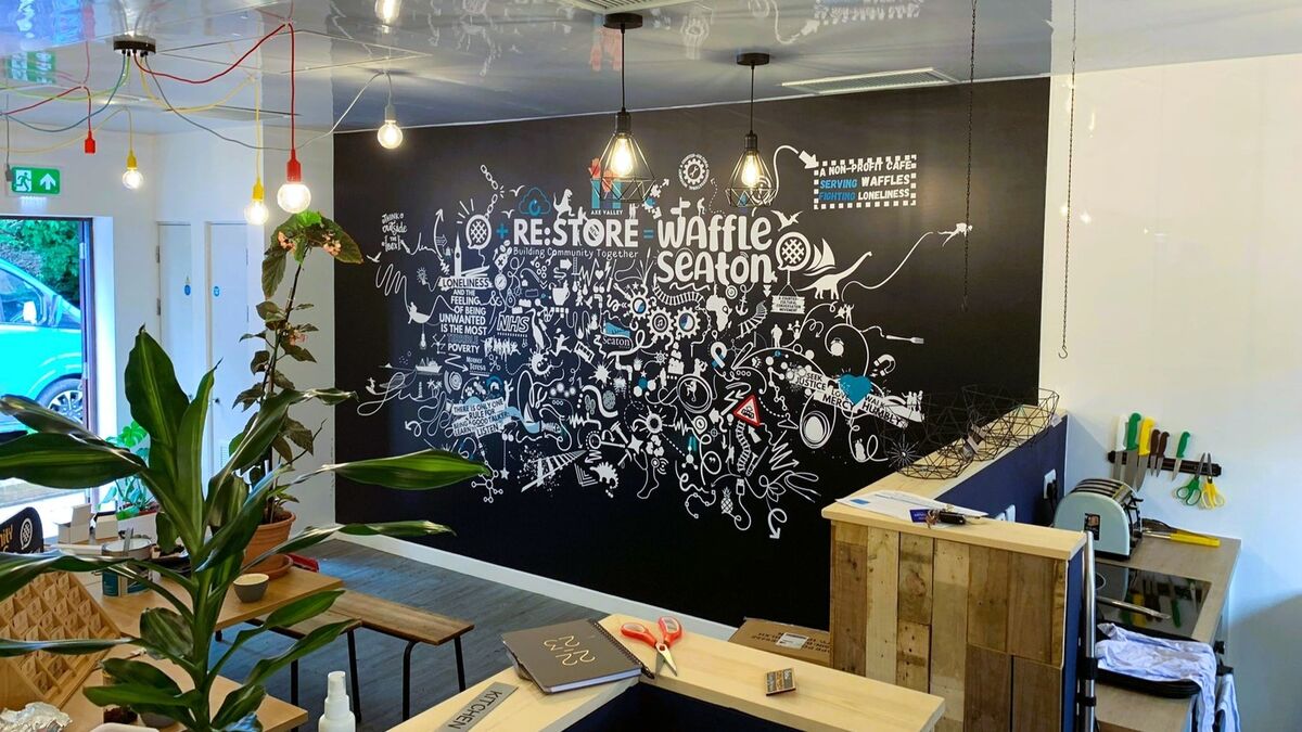 custom printed wallpaper display for the community waffle house in axminster. black, blue and white word clou design.jpg