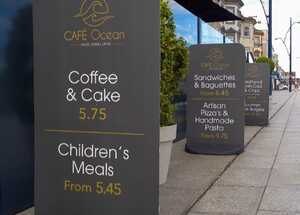 Three Ecoflex 2 Pavement Signs outside restaurant showing Cafe Ocean artwork