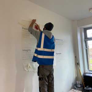 Tacking the vinyl to the wall before application