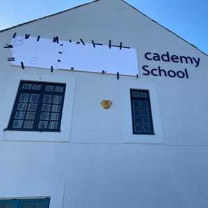 Lettering being applied to the building face with Snapfix Locators