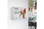 Wall mounted leaflet holder in clear styrene with brochure.png
